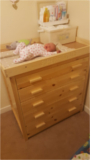 The baby changing table top, has the babies name engraved on the front